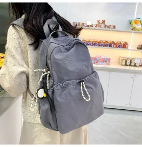 Solid color nylon backpack for women, large capacity stylish school bag for casual daily travel.