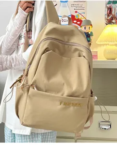Detail view of the stylish large capacity beige backpack with front pocket and side storage.