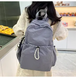 Detail view of casual grey nylon backpack with drawstring closure, lightweight travel daypack.
