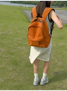Detail view of Korean style orange canvas backpack for students, casual daily use.