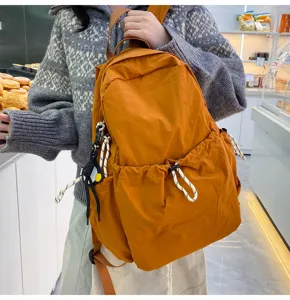 Solid color nylon backpack for women, large capacity casual school bookbag travel daypack.