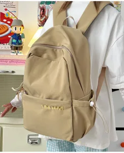 Minimalist khaki casual backpack for women, large capacity travel schoolbag daily use.