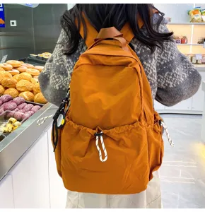 Detail shot of solid color nylon backpack in a casual scene, showcasing large capacity and design.