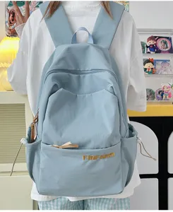 Casual light blue canvas backpack with large capacity, multi-pocket design for daily use.
