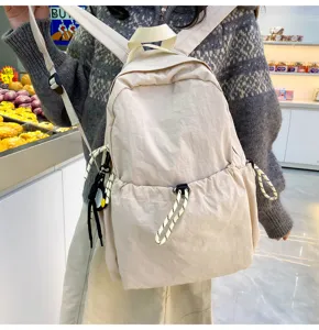 Nylon backpack detail view showing adjustable shoulder straps and convenient drawstring pocket.
