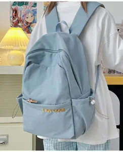 Detailed shot of a simple light blue large capacity canvas backpack, versatile daily travel bag.