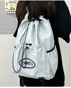 Detailed view of lightweight grey drawstring backpack with black straps and pocket.