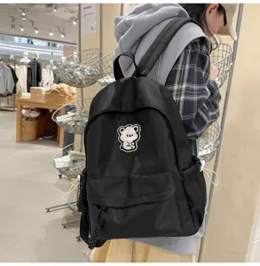 Black canvas backpack for students, cute bear patch, casual daily school bag and daypack.