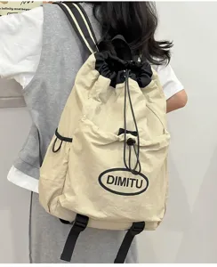 Outdoor lightweight drawstring backpack detail view, beige nylon fabric with black straps.