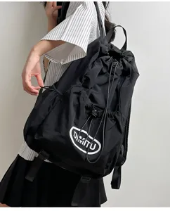 Outdoor black drawstring backpack detail, lightweight nylon fabric and adjustable cord design.