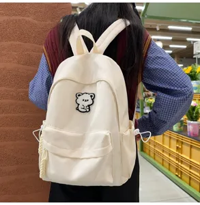 Casual minimalist cream backpack for students with cute bear patch, stylish daily school bag.
