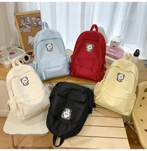 Student casual backpack in multi colors, cute bear patch, lightweight canvas school bag for girls.