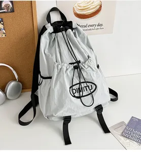 Detail view of the lightweight drawstring backpack with black straps and pocket design.