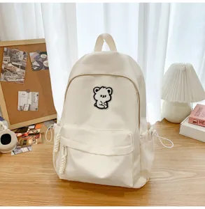 Minimalist aesthetic school backpack with cute bear patch, casual student bookbag for girls.