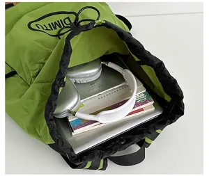 Green lightweight drawstring backpack detail, gorpcore outdoor sports travel pack.