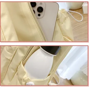 Detailed view of the yellow student casual canvas backpack, showing inner pockets.