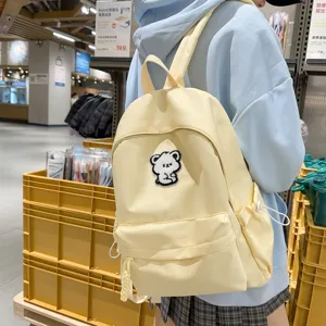 Cute yellow canvas school backpack for teen girls, minimalist daily casual daypack with bear patch.