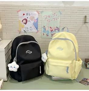 Mochila de lona elegante para estudiantes con colgantes bonitos, ideal para la escuela y uso diario.