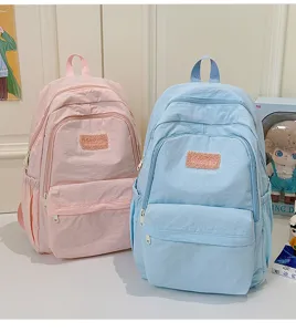 Close-up detail of casual student backpack in pink and blue, lightweight fabric design.