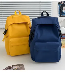 Detail view of Japanese style minimalist solid color nylon backpack, casual school bookbag.