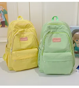 Minimalist canvas casual backpack for students, cute school bag in yellow and green colors.