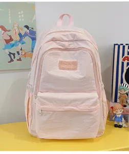 Pink school backpack detail view showing soft fabric, front pocket, and cute daily style setup.