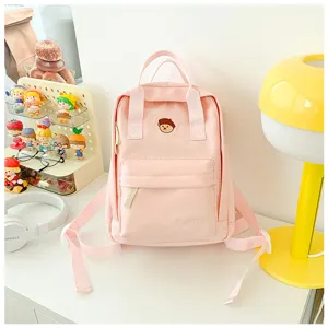 Casual pink canvas school backpack for teen girls and college students, daily chic daypack.
