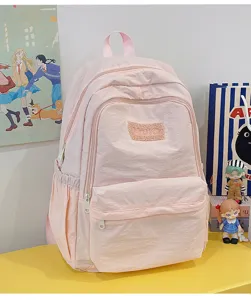 Ins style pink casual school backpack for women, lightweight minimalist daily daypack bag.