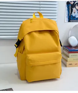 Yellow nylon backpack detail view, casual school bag, multiple pockets, daily use and travel ready.