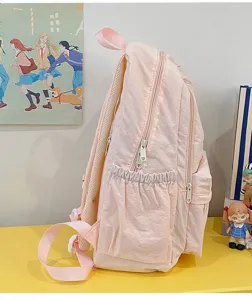 Pink minimalist school backpack side detail showing durable zipper pockets and comfortable straps.