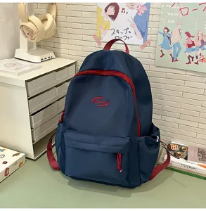 Detalle de mochila informal para estudiantes con tela azul oscuro y cremallera roja.
