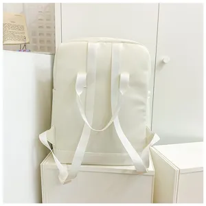 Minimalist white daily backpack detail view, clean design with dual straps and carry handle.