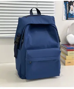 Detailed view of casual blue nylon backpack on white desk with books and headphones.
