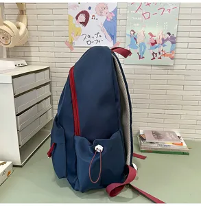 Mochila escolar de lona con cremalleras rojas y bolsillos laterales para uso diario