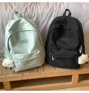 Casual minimalist solid color school backpack with cute cloud pendant for daily use and students.