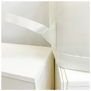 White canvas backpack detail close-up showing durable strap stitching and premium fabric quality.