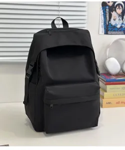 Black nylon casual backpack detail showing multiple zippered pockets and durable side buckles.