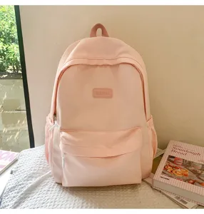 Pink casual school backpack for students, simple solid color daily travel daypack bag.