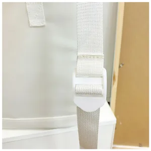Close-up detail of white backpack strap and adjustable plastic buckle showcasing fine workmanship.
