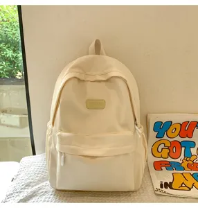 Minimalist solid color casual student backpack, durable daily school bag detail view.