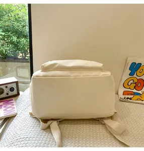 Detailed view of the solid color minimalist student backpack, casual beige book bag for daily use.