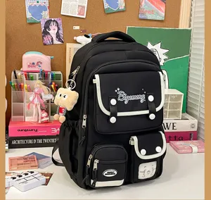 Detailed view of casual black college backpack with multiple pockets and cute charms in lifestyle setting.
