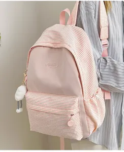 Pink and white checkered school backpack for daily travel, featuring large capacity and pockets.