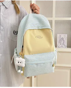 Ins style Japanese plaid backpack, cute yellow splicing school bag with plush cloud pendant for daily use.