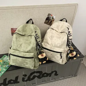 Vintage style large capacity canvas backpack for students, trendy casual school bag with pendant.