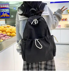 Black nylon backpack detail view, featuring large capacity and casual daily school style.