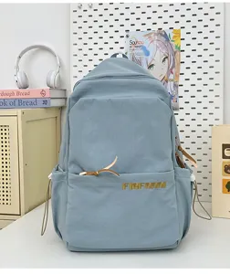 Casual light blue canvas backpack with front pocket and leather ties for daily commute.