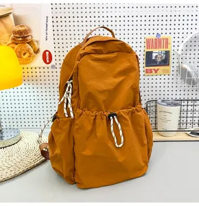 Solid color nylon backpack for women, large capacity casual school bag for daily travel.