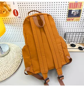 Solid color nylon backpack detail view, casual school bag and lightweight travel daypack.