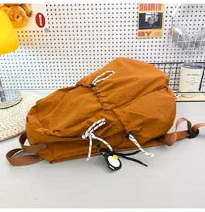 Detailed view of stylish brown nylon backpack featuring drawstring and speckled straps.